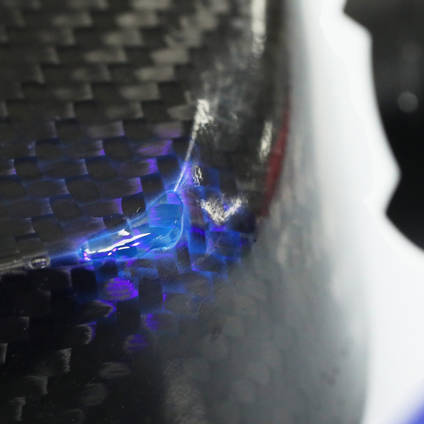 Using a UV torch to cure 130UV adhesive to repair a void on a carbon fibre part